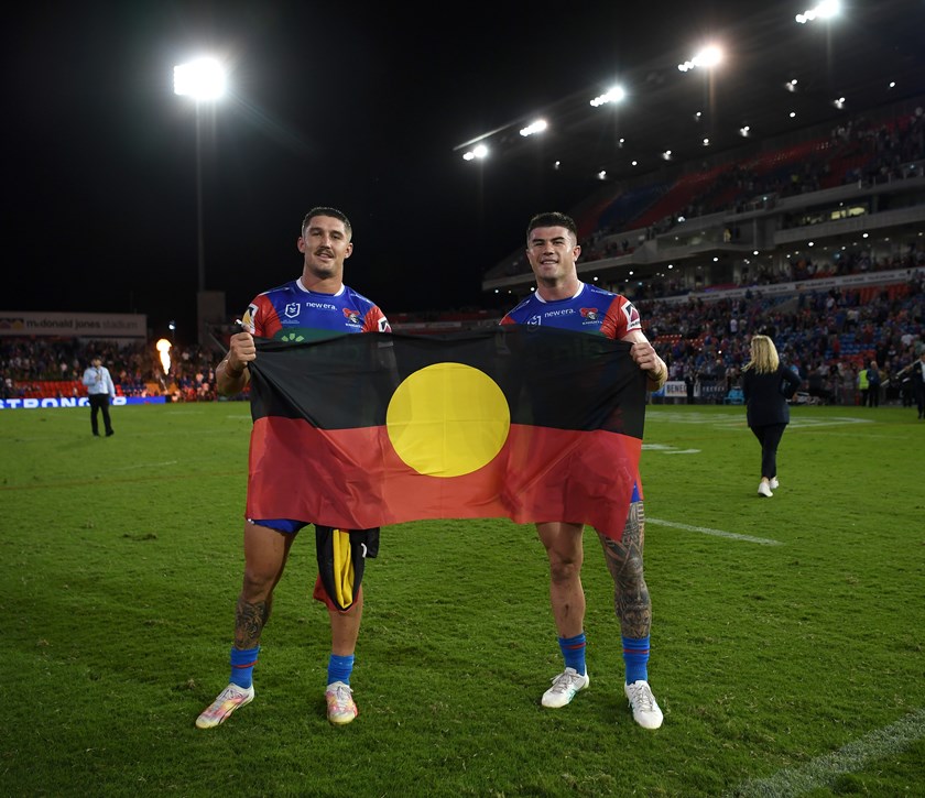 Teammates Dylan Lucas and Bradman Best flying the Indigenous flag in Multicultural Round.
