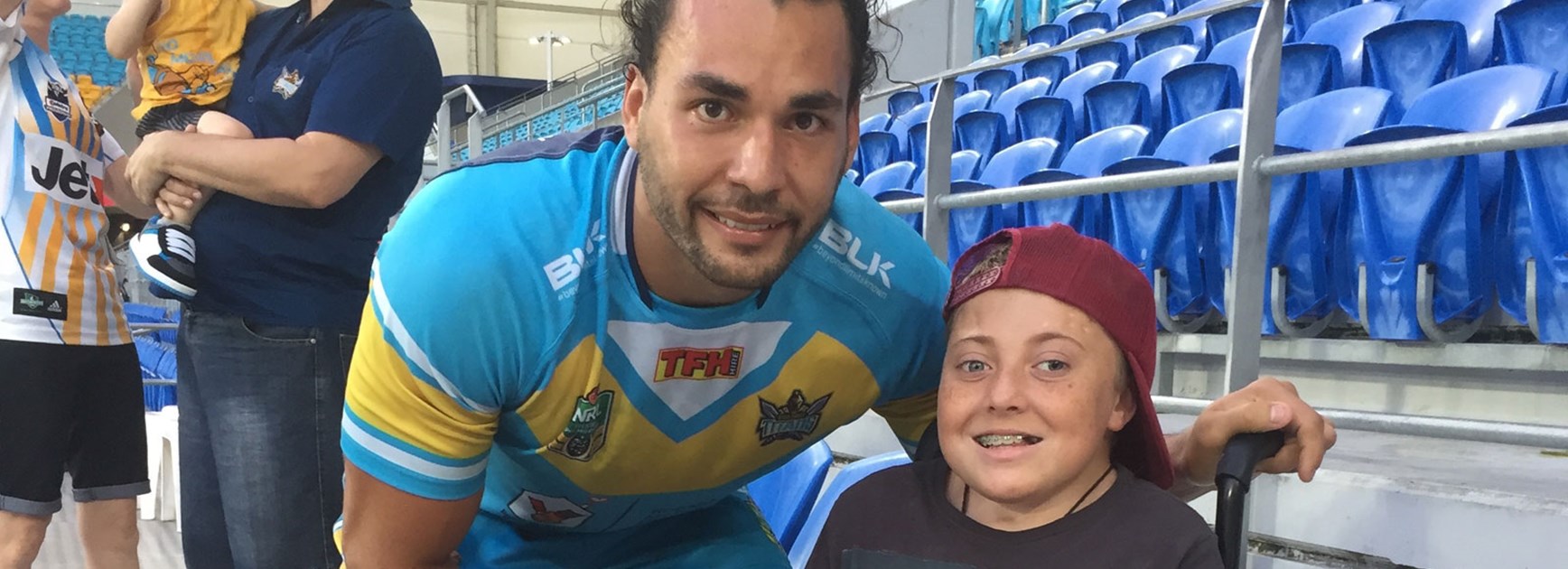 Titans forward Ryan James with inspirational young fan Harrison Wheatley.