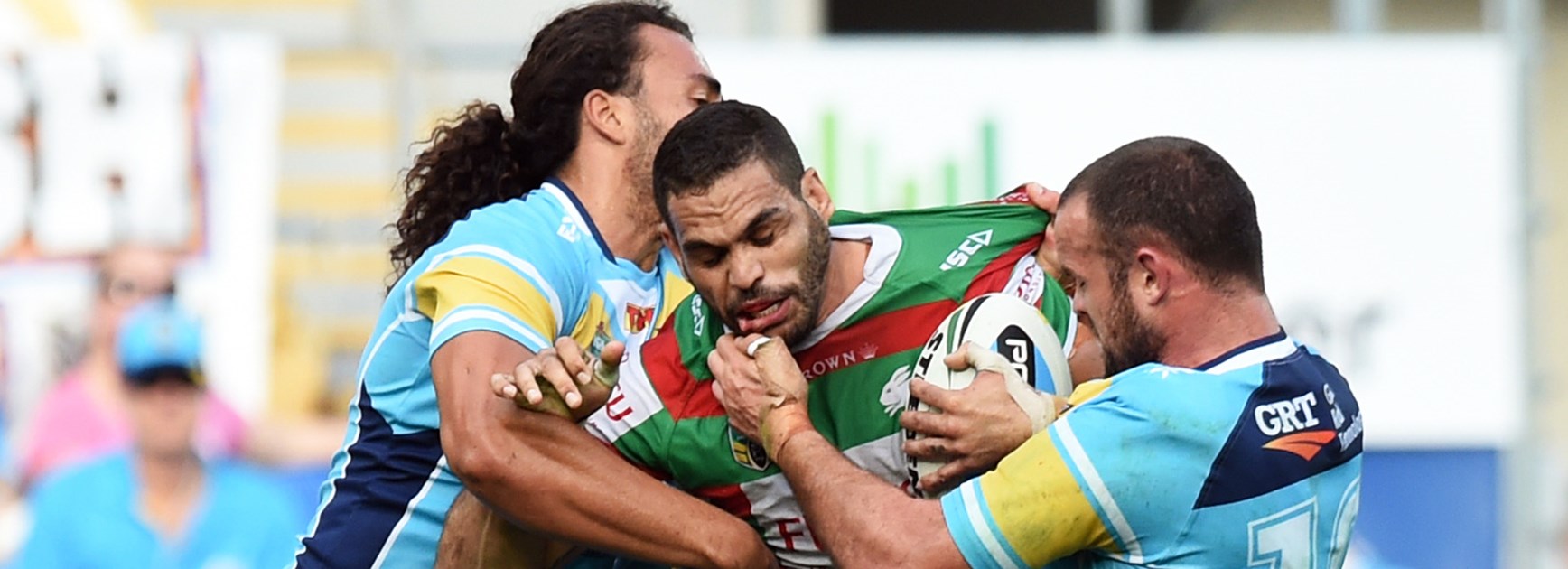 Greg Inglis is tackled by Titans forwards Ryan James and Nate Myles on Saturday.
