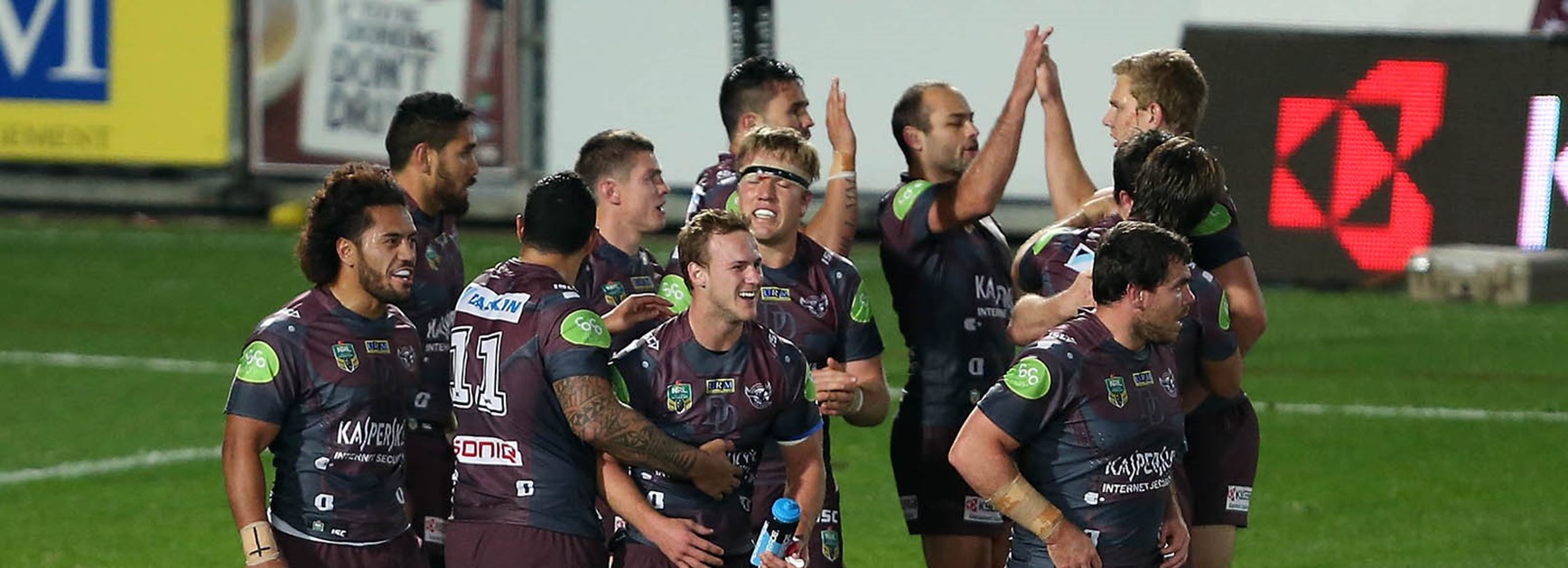 Manly players celebrate another try against the Broncos in Round 21.