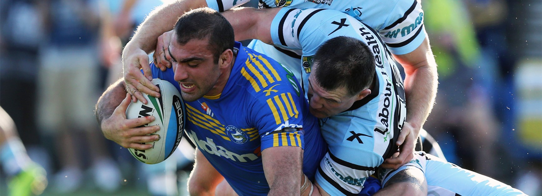Tim Mannah is brought down by the Cronulla defence.