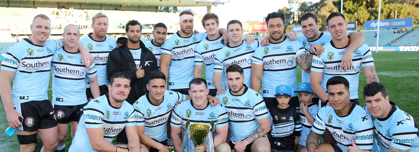 The Cronulla Sharks celebrate with the Johnny Mannah Cup after defeating Parramatta in Round 25.