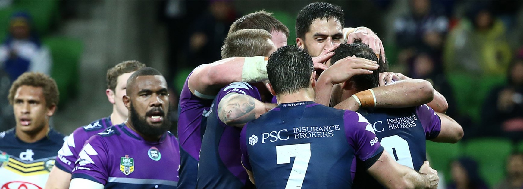 The Melbourne Storm celebrate their first-half try against the Cowboys on Saturday night.