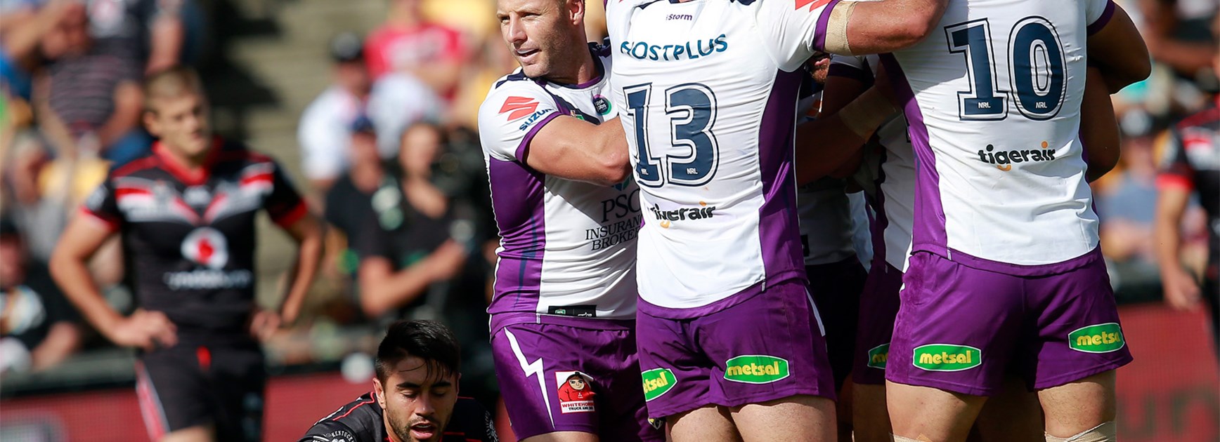 The Melbourne Storm celebrate an early try against the Warriors on Sunday.