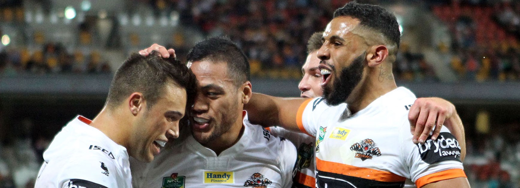The Wests Tigers celebrate a try to Tim Simona against the Broncos at Suncorp Stadium.