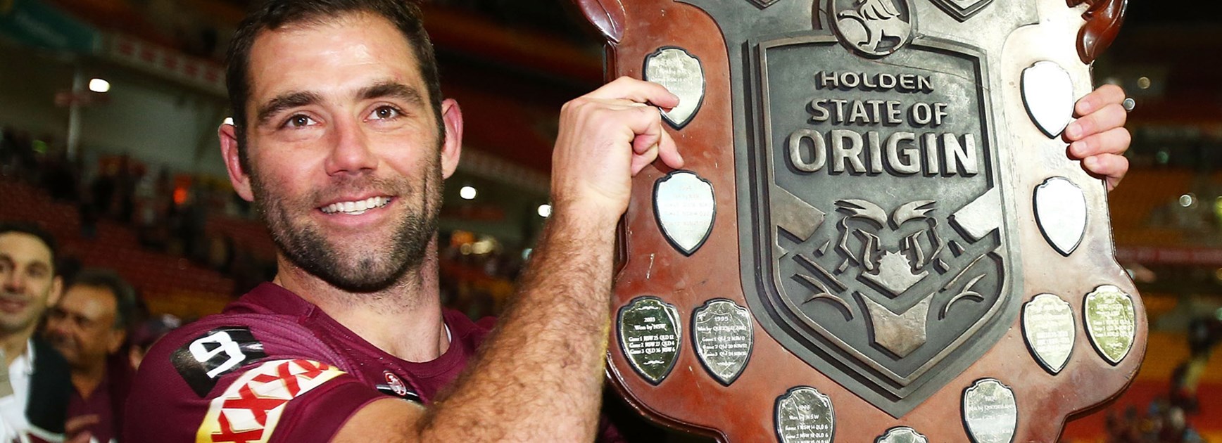Cameron Smith holds the Origin shield following his side's win in the decider.