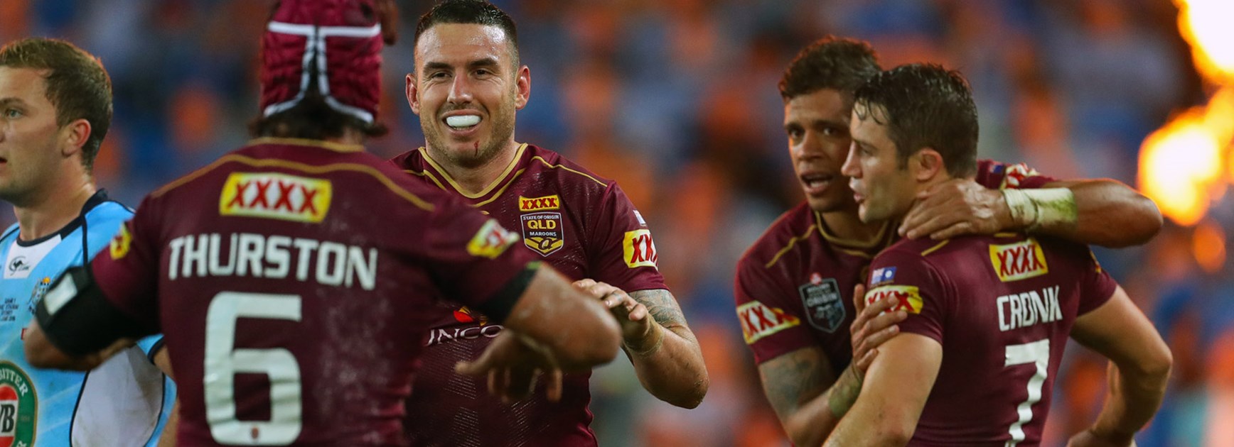 Queensland players celebrate during the opening game of the 2016 Origin series.
