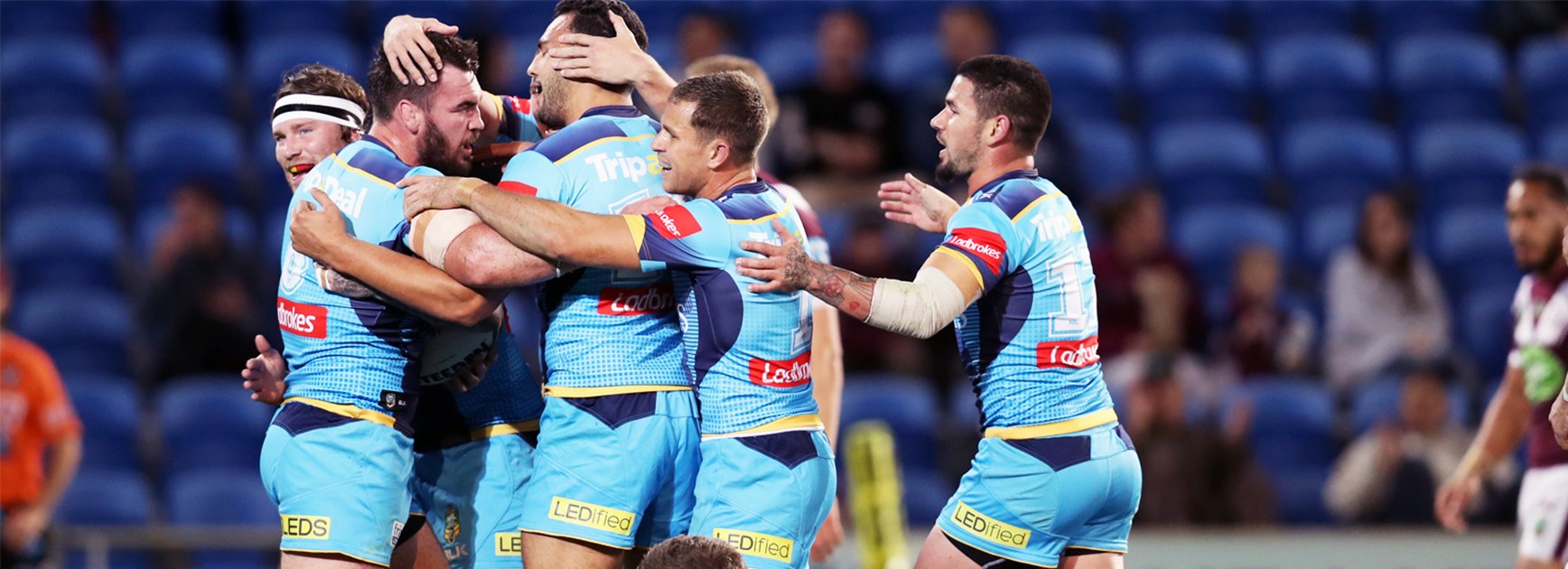 The Titans celebrate Luke Douglas's opening try against Manly on Monday.