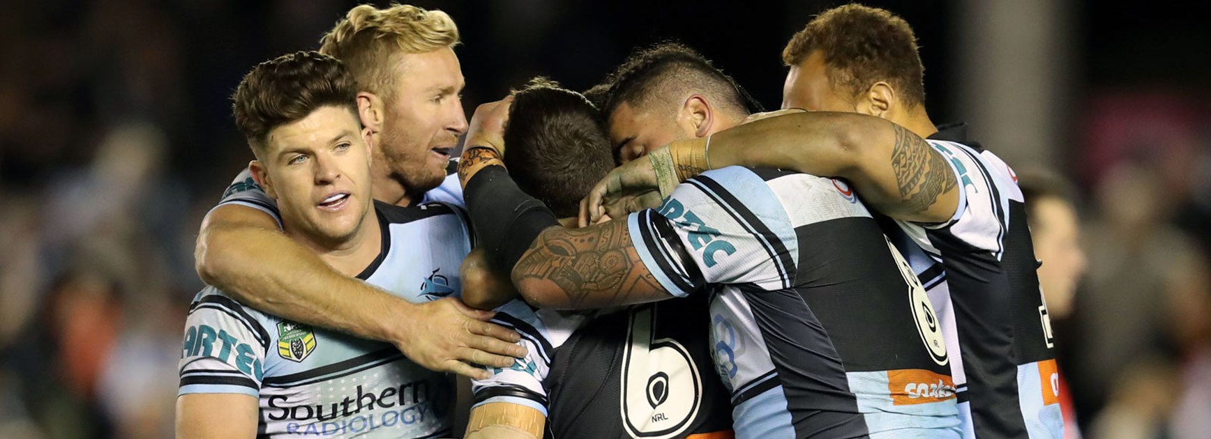 Sharks players celebrate James Maloney's winning field goal against the Warriors.