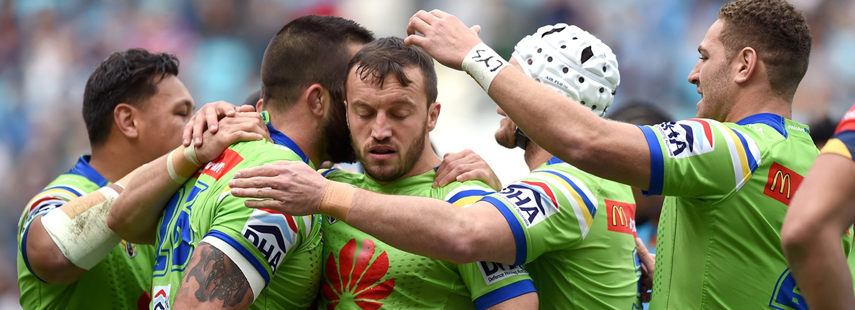 The Canberra Raiders celebrate a try against the Titans.