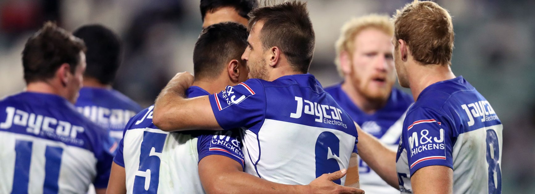 Bulldogs players celebrate their win over the Roosters in Round 17.