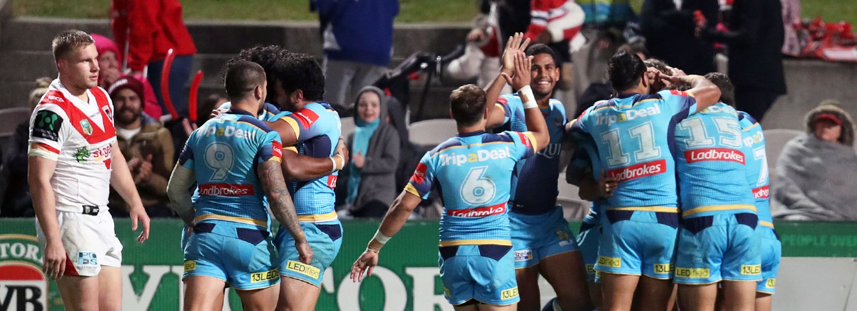 Titans players celebrate against the Dragons in Round 19.