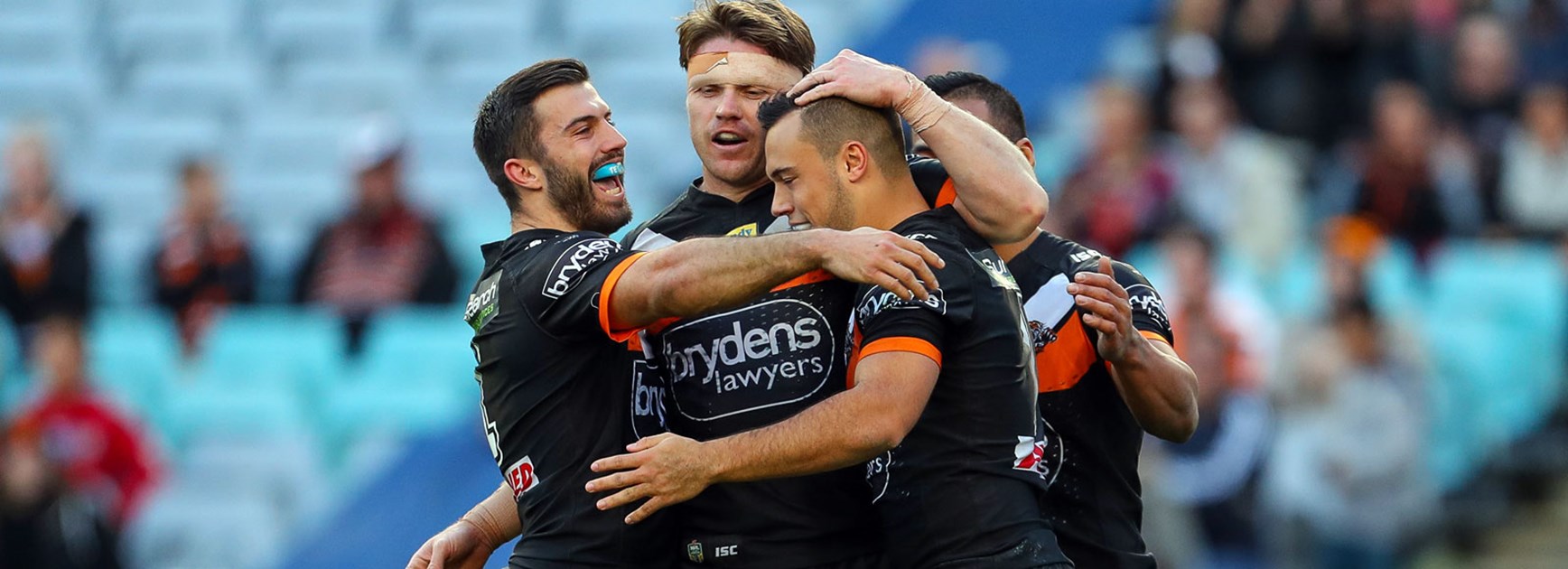 Tigers players celebrate against the Dragons in Round 20.