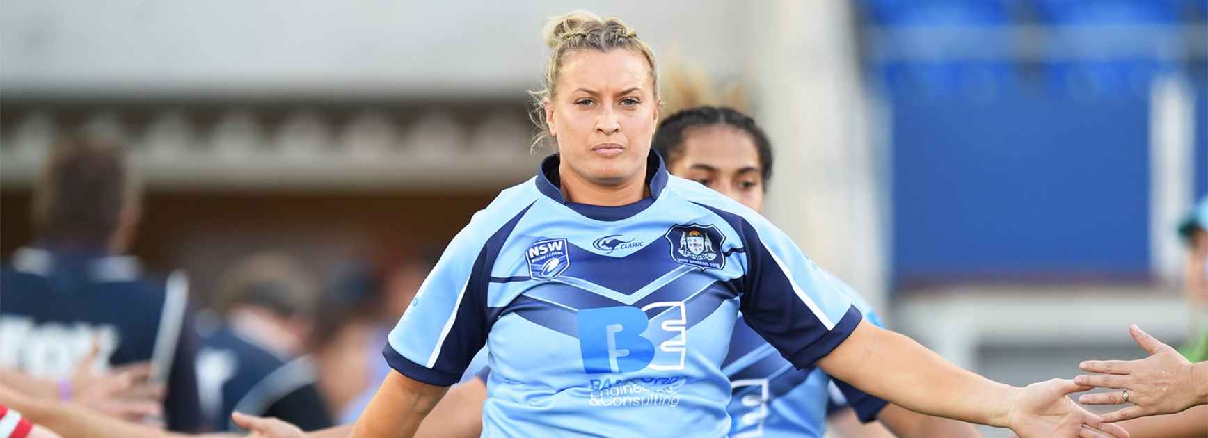 Ruan Sims leads out the women's NSW team to face Queensland last week.