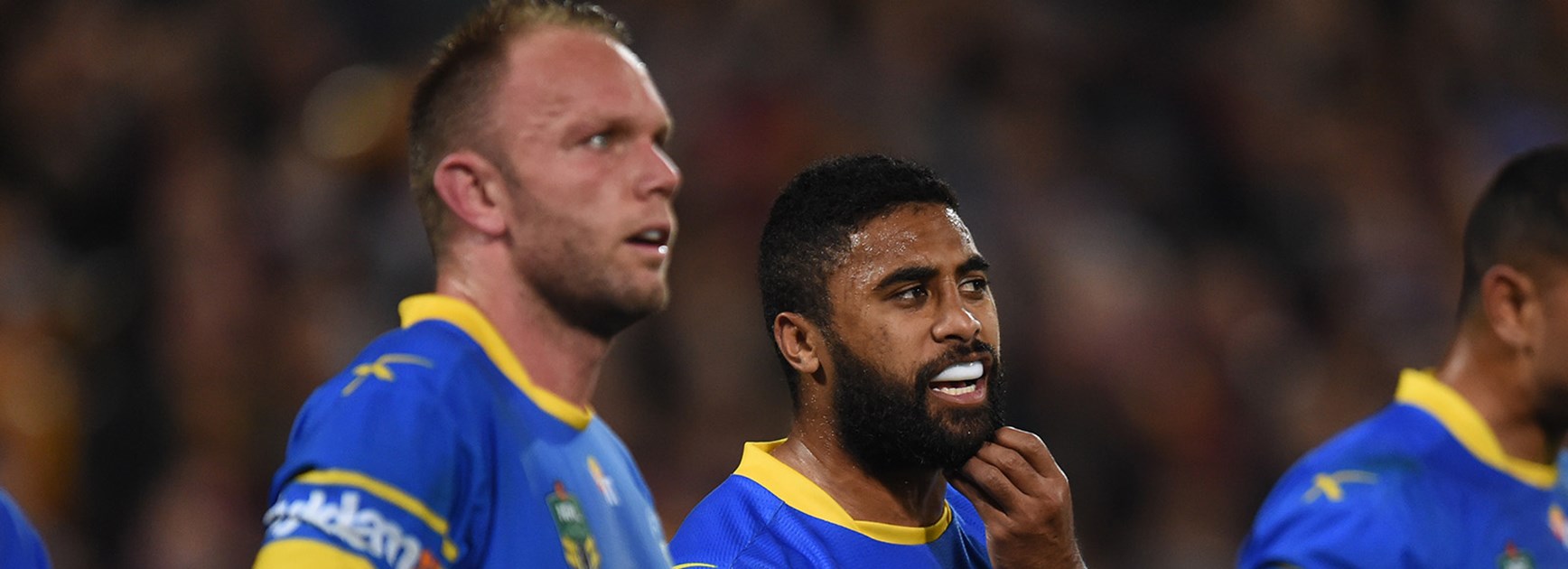 The Eels look on dejected after another Broncos try.