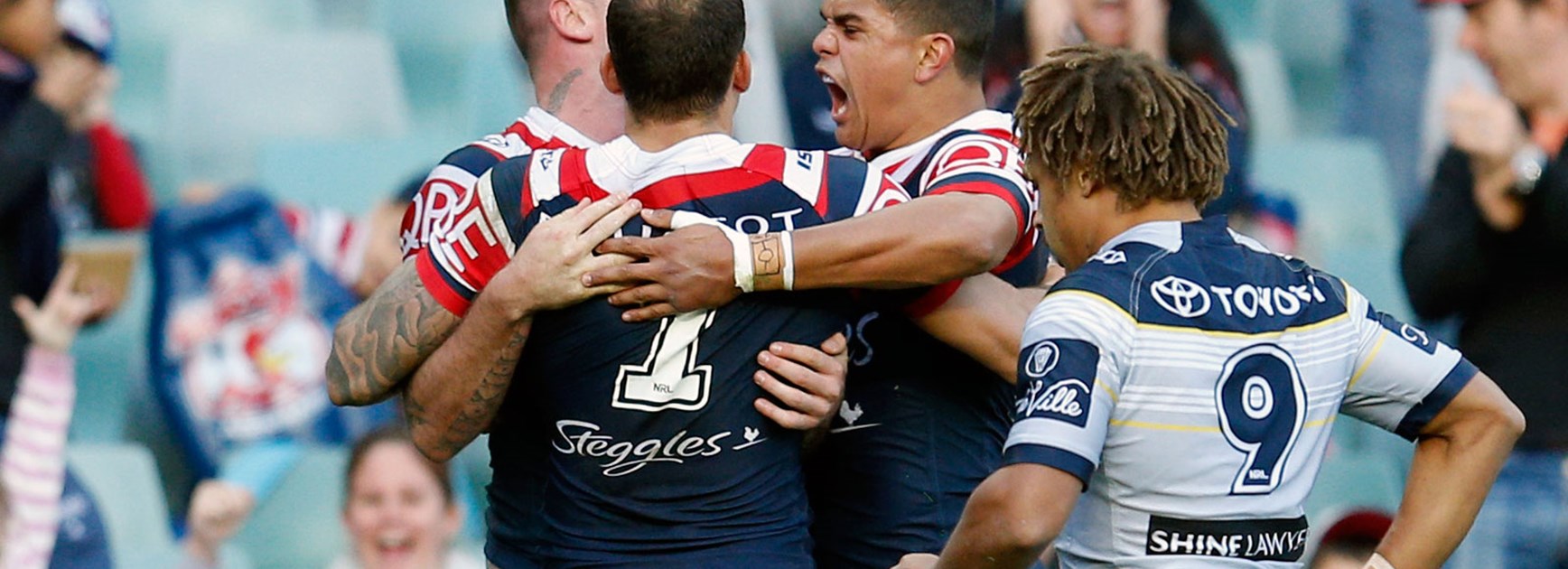 Roosters players celebrate against the Cowboys in Round 23.