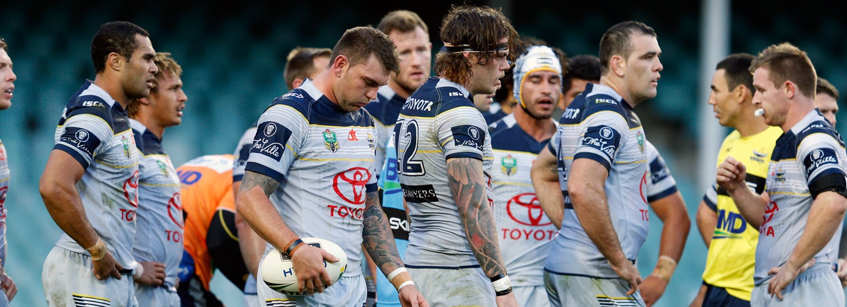 Cowboys players look on dejected against the Roosters in Round 23.