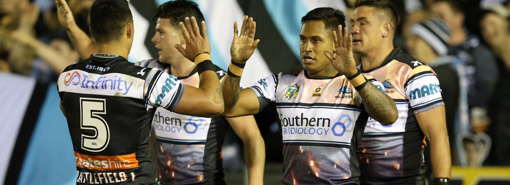 Sharks players celebrate during their win over the Roosters in Round 25.