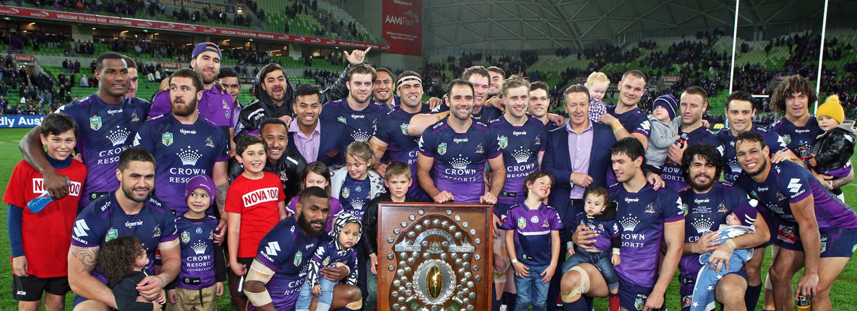 Storm players celebrate with the JJ Giltinan Shield following their win over the Sharks.