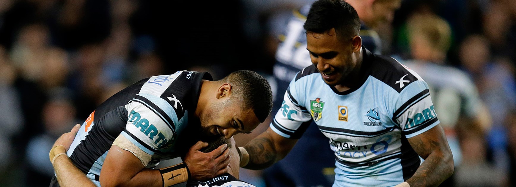 Sharks celebrate another try during the preliminary final against the Cowboys.