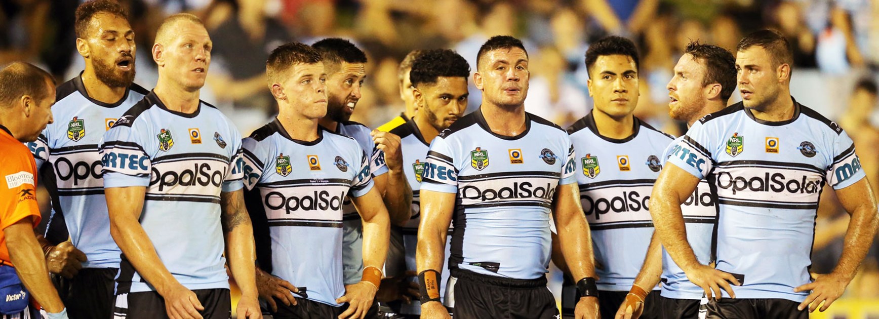 Sharks players look on during their opening round loss to the Broncos.