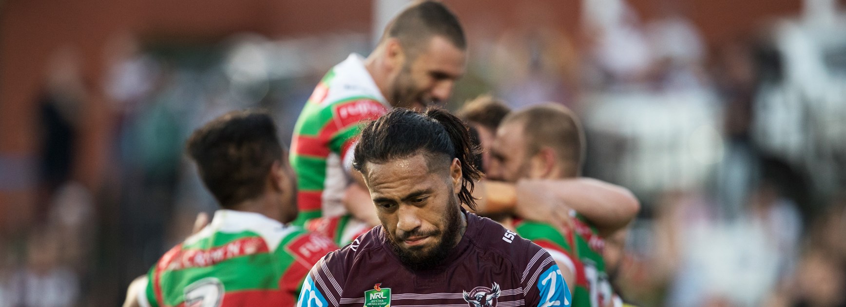 Manly's Jorge Taufua and celebrating Rabbitohs players.