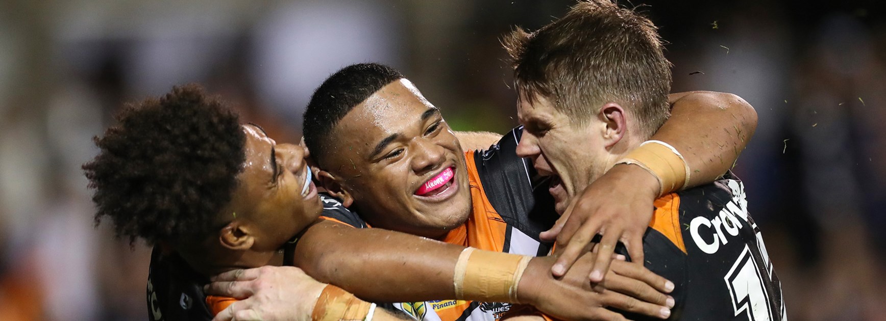 The Wests Tigers celebrate Moses Suli's first-half try against the Sharks.