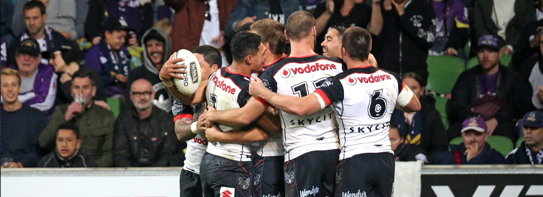 Warriors celebrate a try against the Storm on Anzac Day.