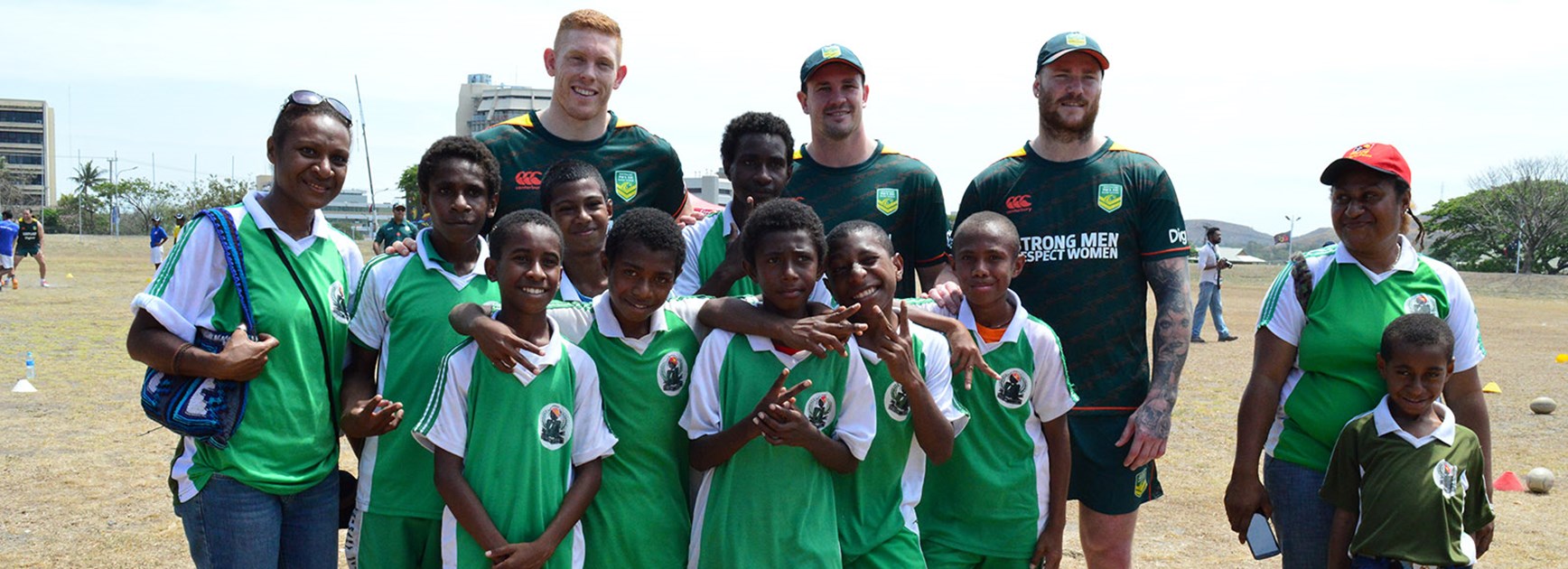 Players from the Australian PM's XIII with PNG school children at a League Bilong Laif holiday clinic.