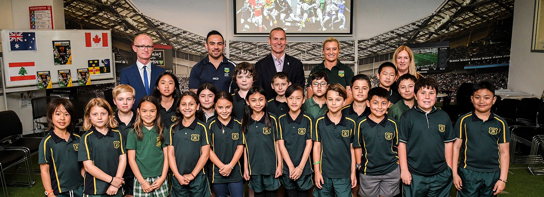 Ruan Sims, Dene Halatau and Andrew Hill join children from Crown Street Public School at Rugby League Central.