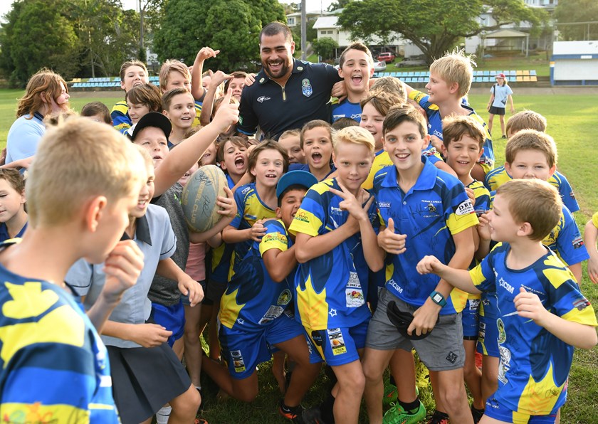 Andrew Fifita is swamped by schoolchildren during a coaching clinic.