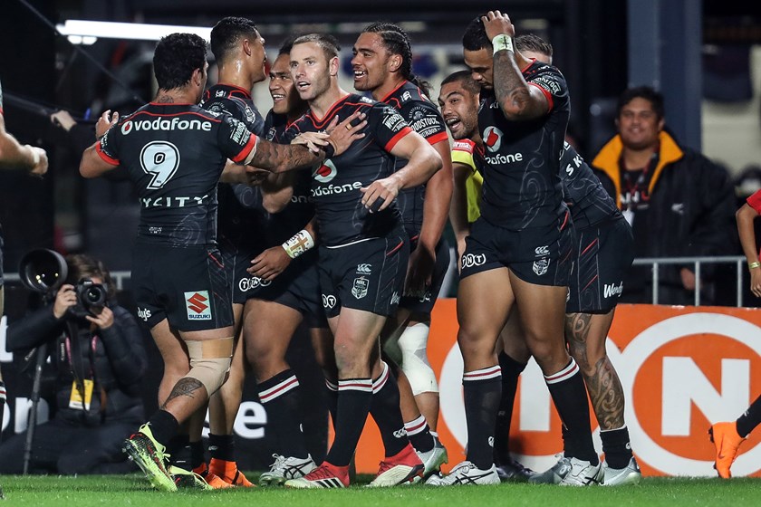 Warriors players celebrate a try.