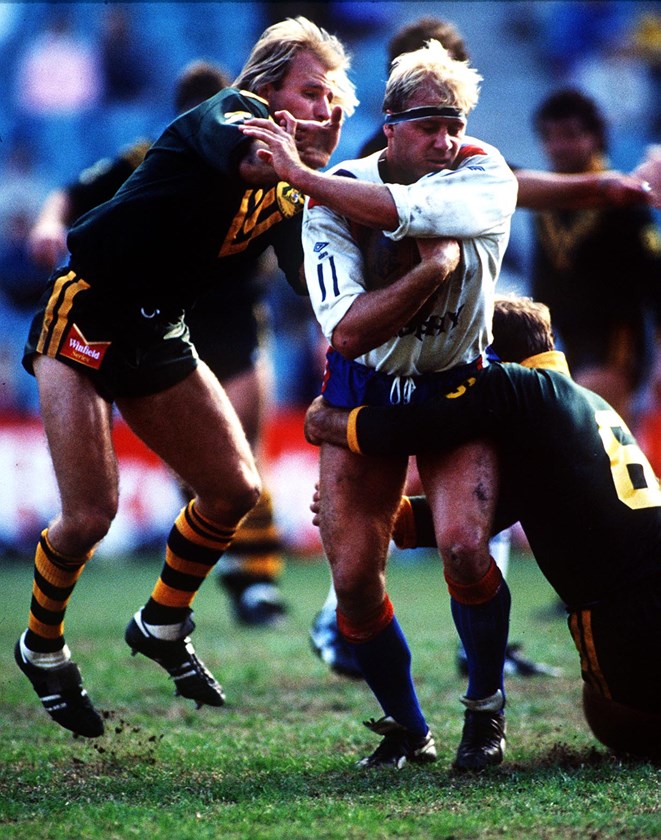 Great Britain forward Mike Gregory tries to shrug off Kangaroos halfback Peter Sterling  and five-eighth Wally Lewis in 1988.