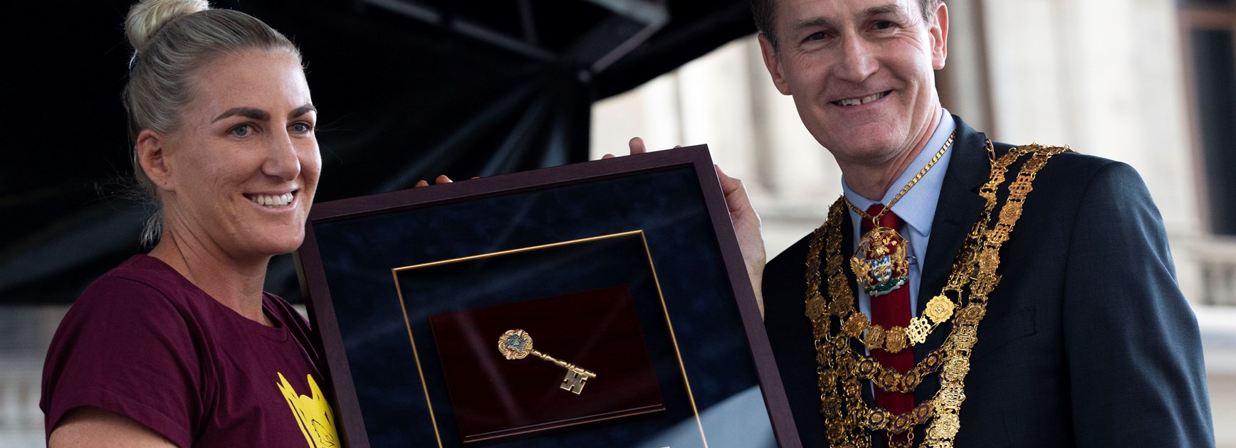 Broncos captain Ali Brigginshaw is presented with the keys to the city by Lord Mayor of Brisbane Graham Quirk.
