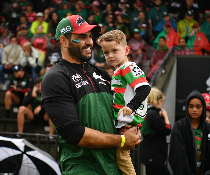 Greg Inglis with John Sutton's son Ace at Redfern Oval.