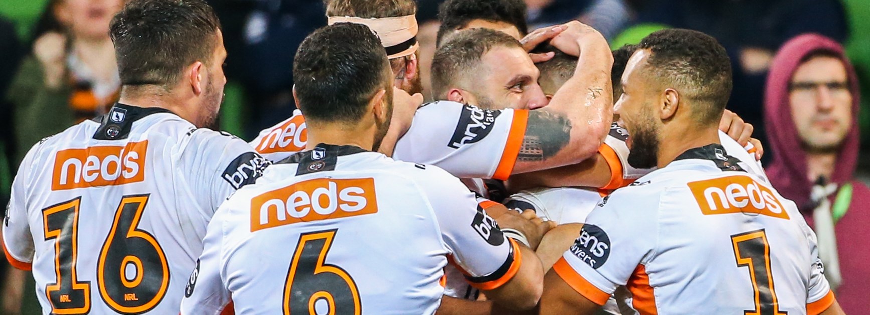 The Tigers celebrate a try against Melbourne.