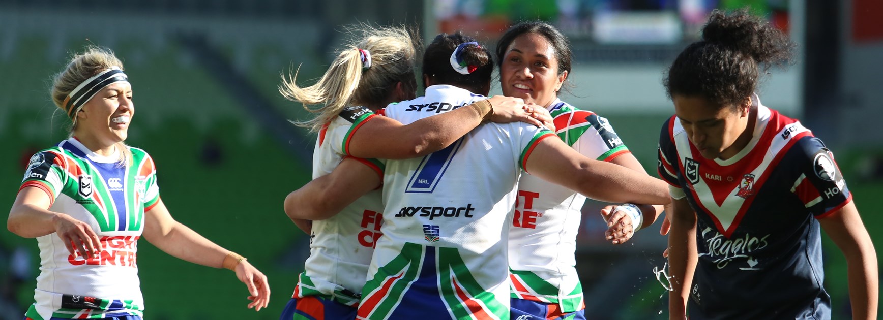 The Warriors congratulate halfback Charntay Poko after her try against the Roosters.