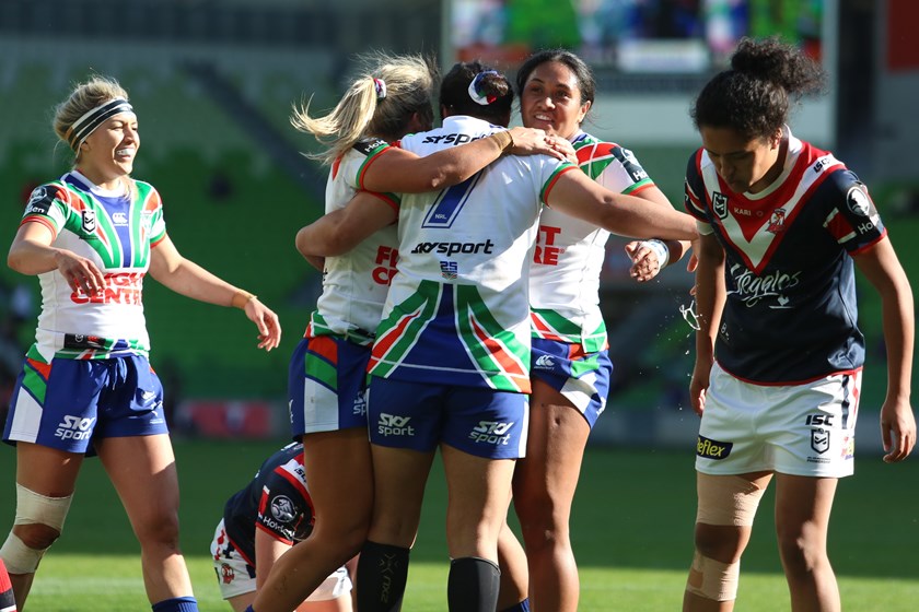 The Warriors congratulate halfback Charntay Poko after her try against the Roosters.