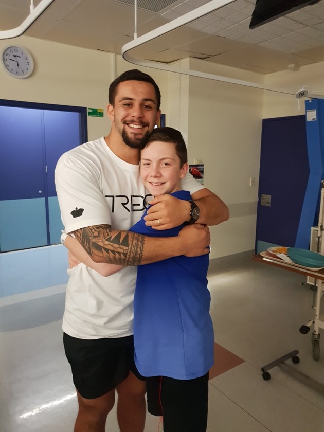 Wests Tigers forward Josh Aloiai and brave Tigers fan Lachlan Fleming.