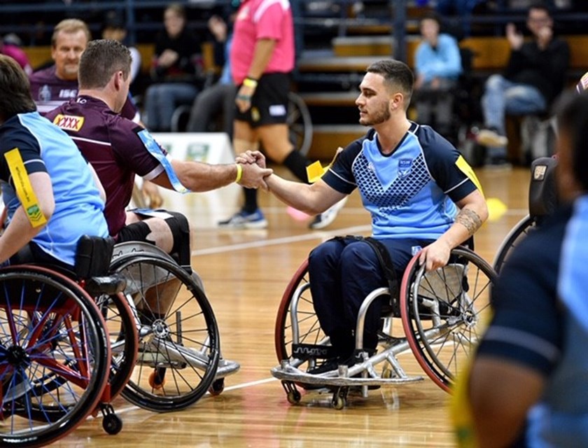 Queenslander Shaun Harre gets acquainted with NSW player Cory Cannane.