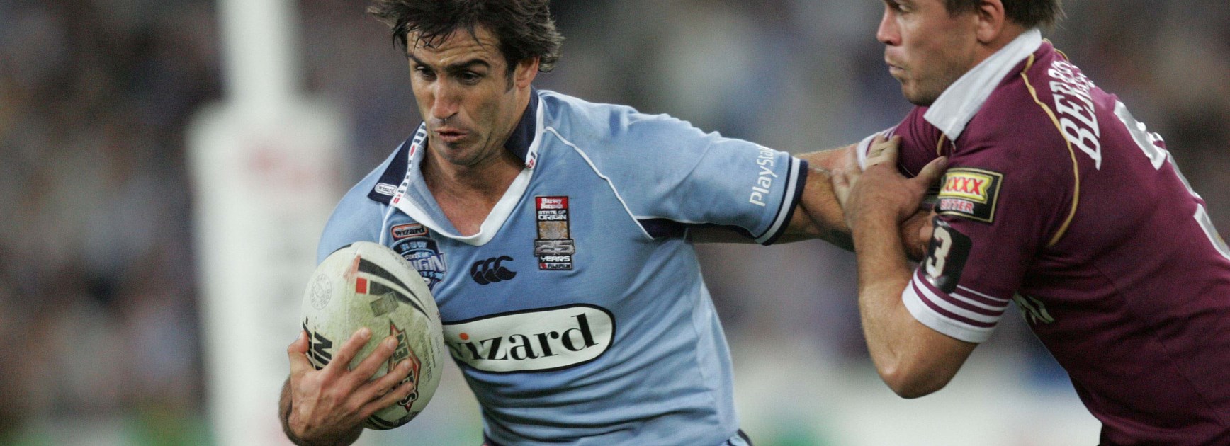 Johns tries to shrug off Shaun Berrigan during his man of the match performance in Origin II in 2005.