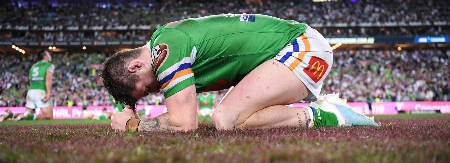 John Bateman collapses to the turf after giving it his all in the 2019 grand final.