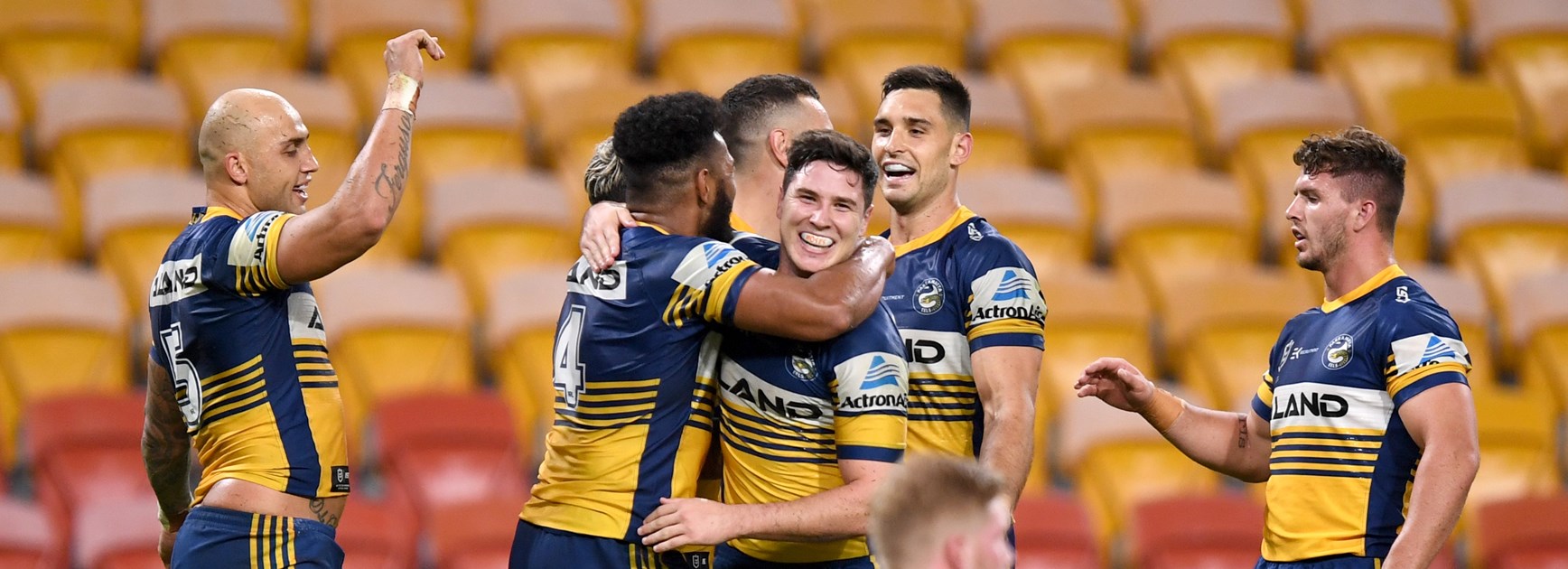 Eels players celebrate a try against Brisbane in front of empty stands in round 3, 2020.