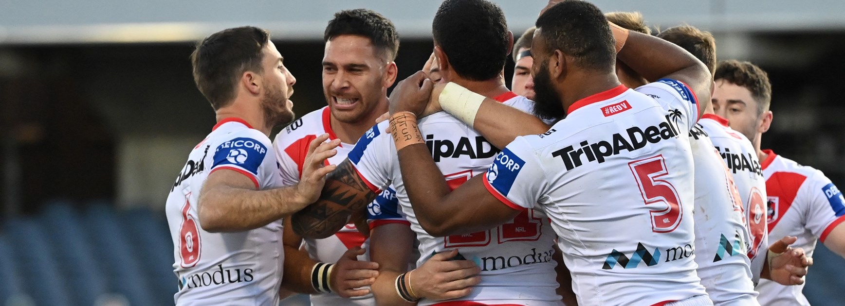 Dragons players celebrate a try.