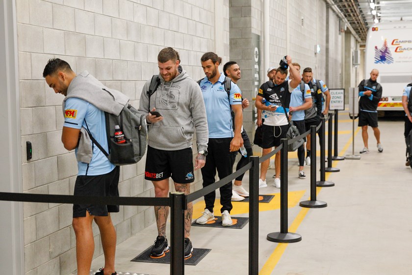 The Sharks line up for temperature checks ahead of their clash with the Cowboys at Queensland Country Bank Stadium.