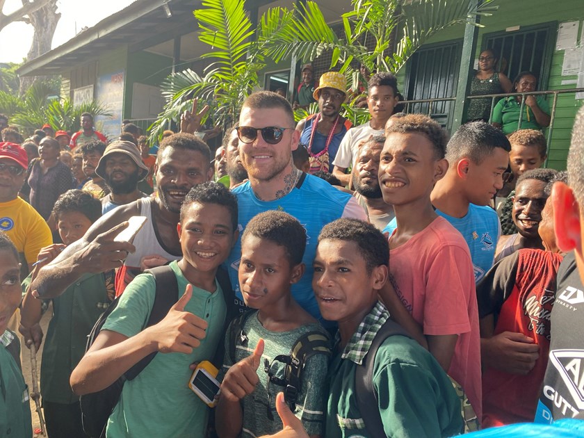 Sharks utility back Josh Dugan is swamped by fans in PNG.