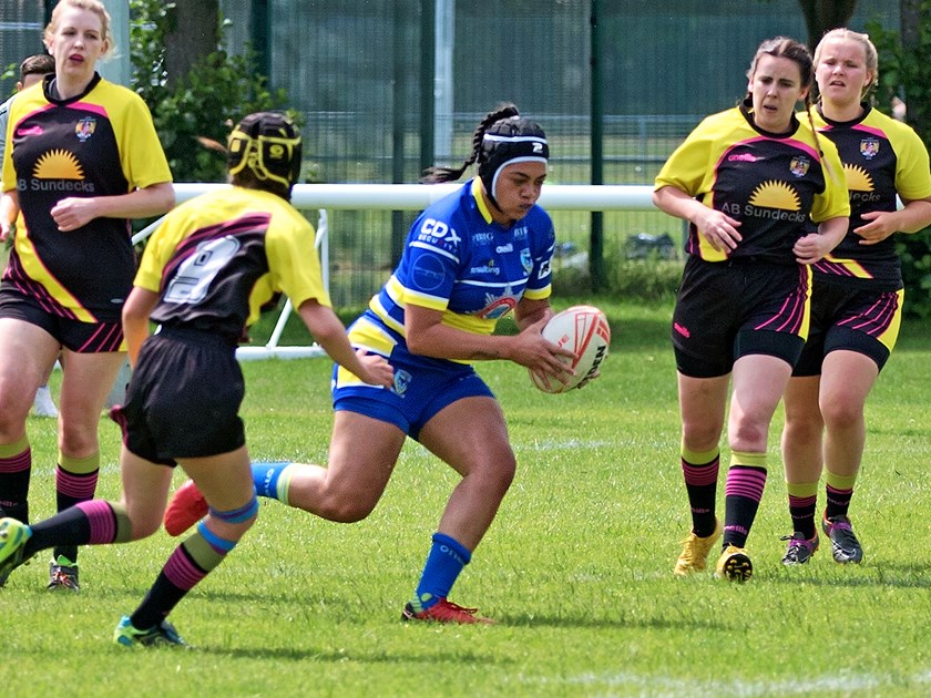 Roxy Murdoh hits the ball up for the Wolves against Leigh Miners.