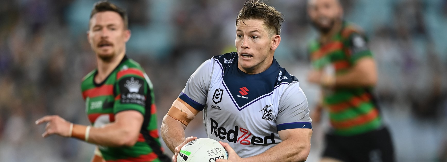 Storm hooker Harry Grant races away from South Sydney's Damien Cook.