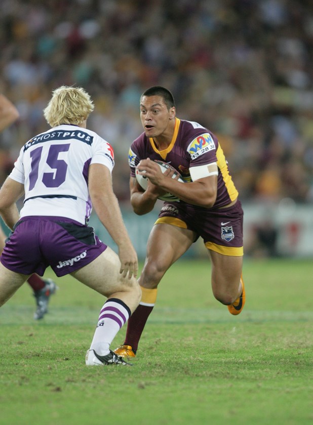 Alex Glenn hits it up for Brisbane against Melbourne's Aiden Tolman in his rookie season of 2009.