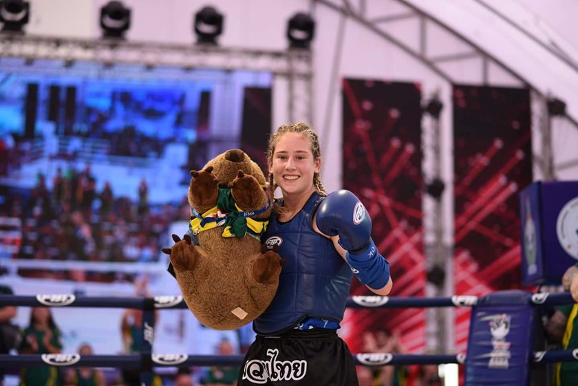 Emily Curtain poses after winning gold at the Muay Thai World Championships in 2018.